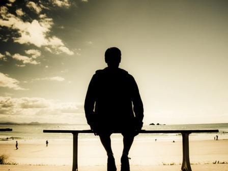 Man sitting all alone on a bench