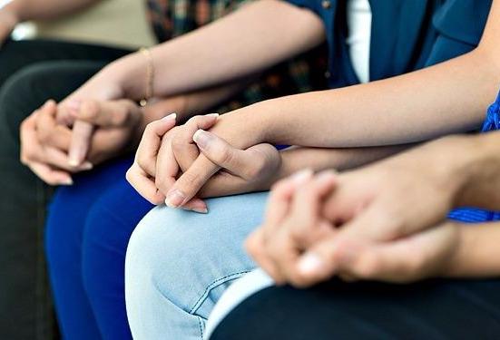 A row of hands holding other hands