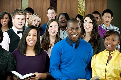 Diverse young people singing in church