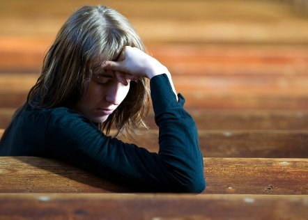 Troubled woman sitting alone