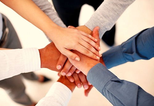 Hands clasped together in a circle