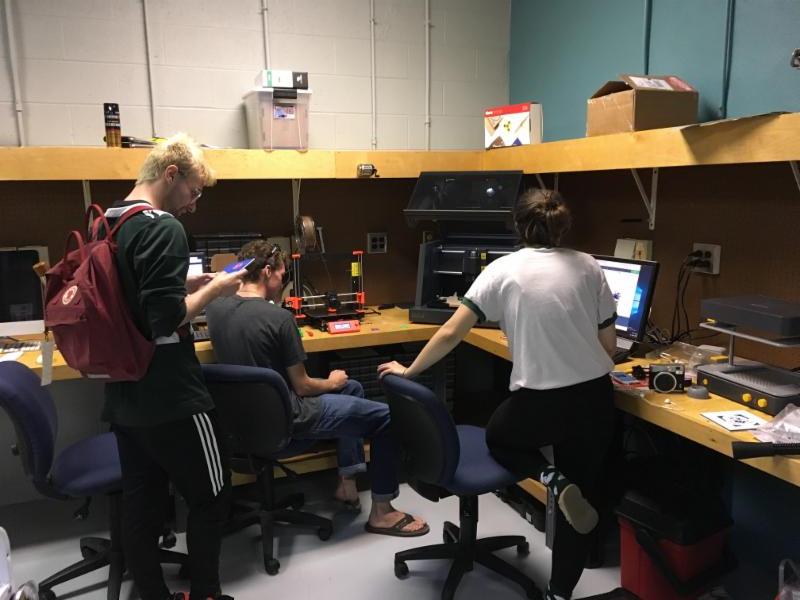 Students from different classes working together to get the desktop mill up and running.