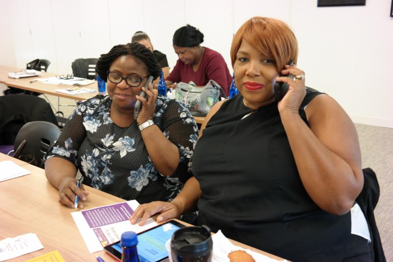 Marie Eloi, Med-Tech, and Maggie Pena Vancol, MSW, phonebanking to save healthcare.