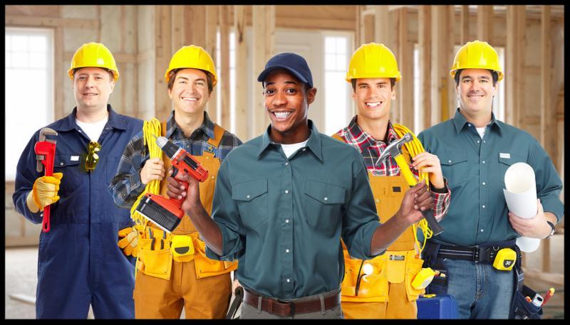 Group of professional construction workers in  new house. Renovation.