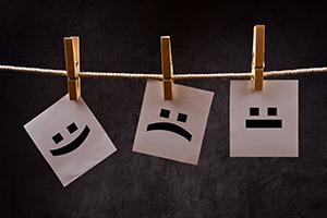 Image of various emotions hanghing on a line.