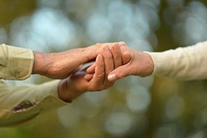 Photo of couple holding hands.
