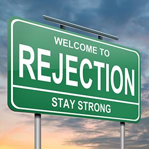 Photo of a sign saying stay strong in the face of rejection.