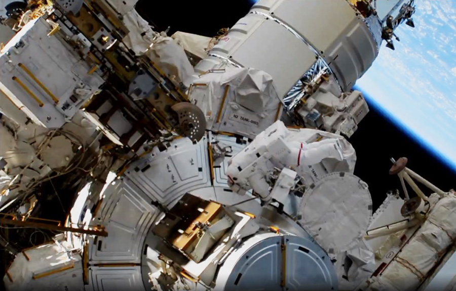 NASA astronaut Jessica Meir enters the Quest airlock to complete a spacewalk after swapping batteries on the International Space Station that store and distribute solar power collected for the solar arrays.