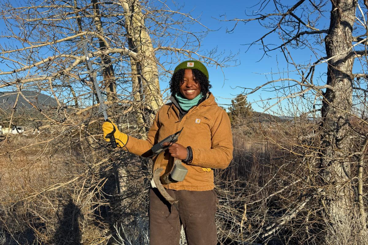 veterinary student in the field with tracking equipment 