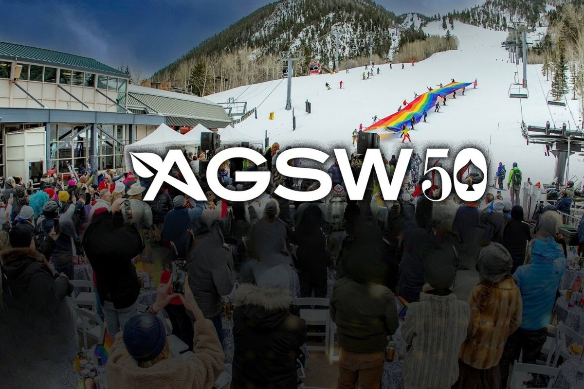 Aspen Gay Ski Week 50: crowds at the base of Aspen Mountain with a giant rainbow flag on the slope