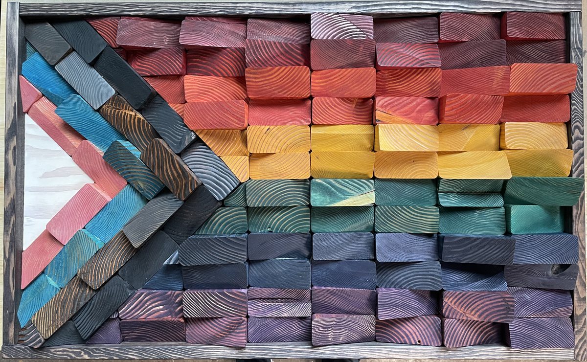 Randy Ackman's handcarved Progress Pride Flag made from more than 100 hand-dyed wooden pieces