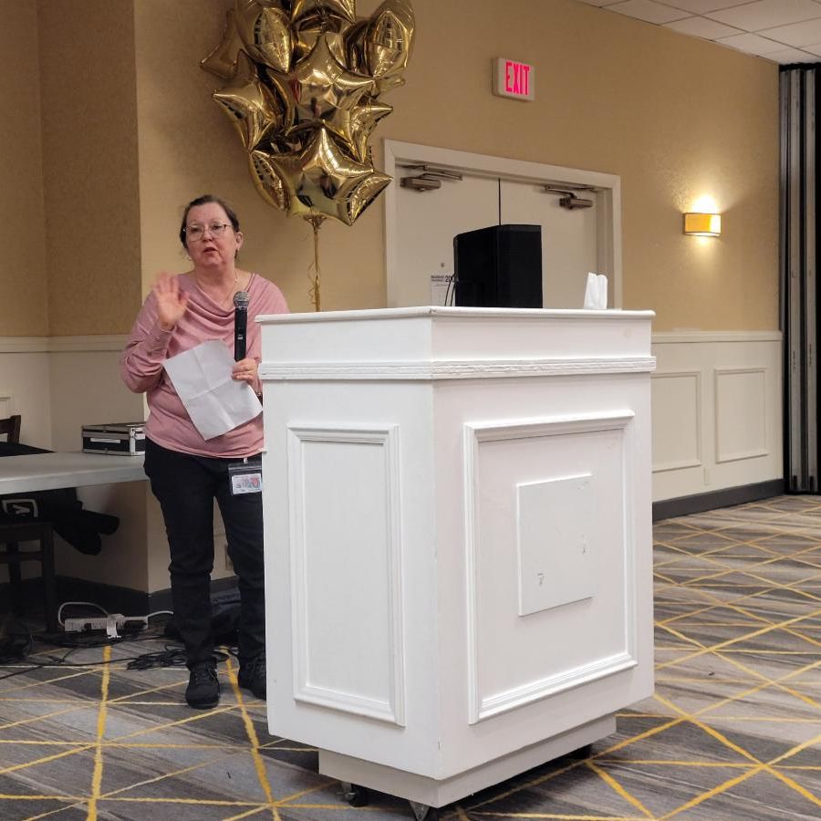 NeArc participants pose with Holy Cow owner Mike Schiano who is holding a big tub of ice cream