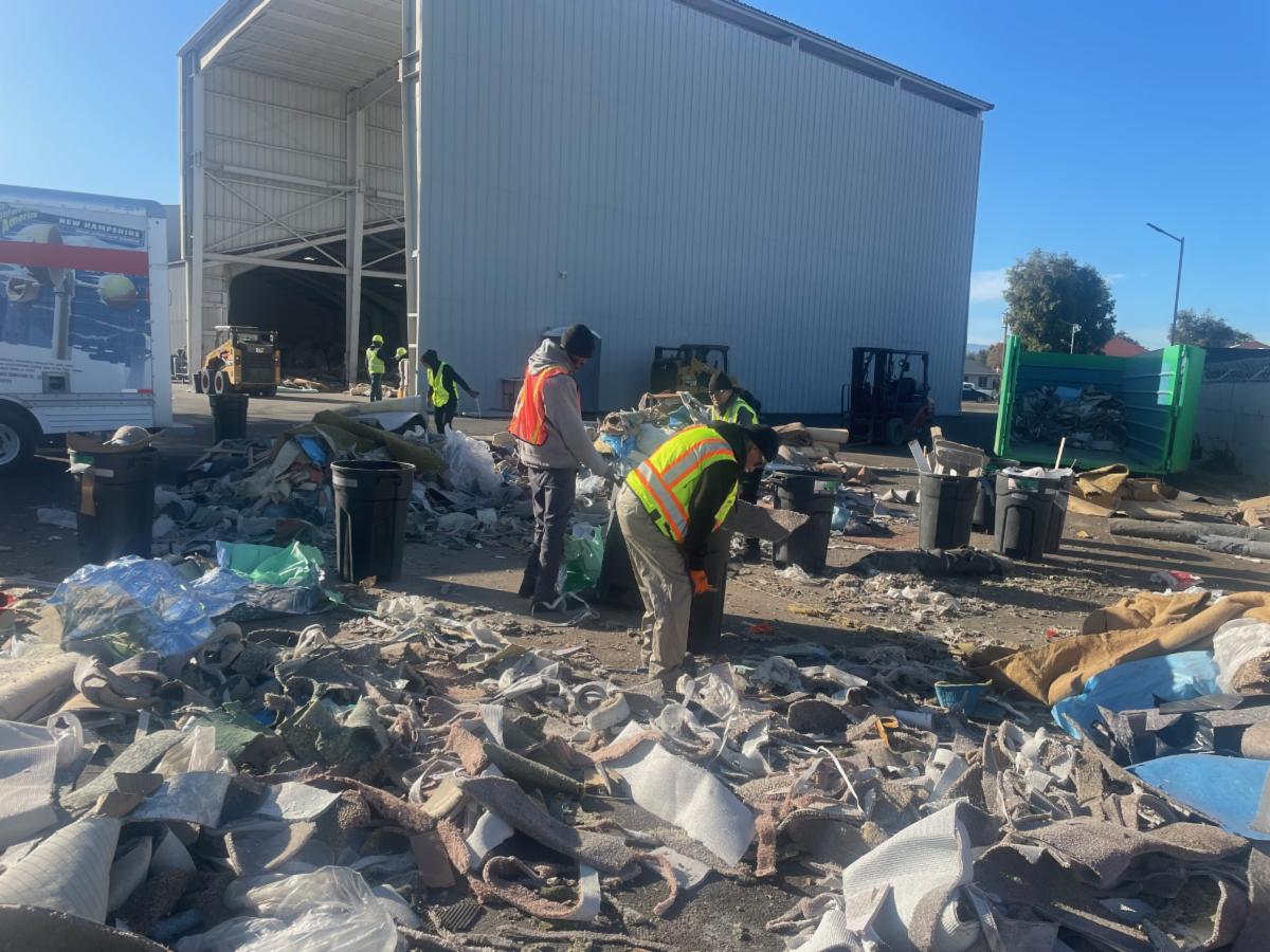 workers sorting through discards at waste facility