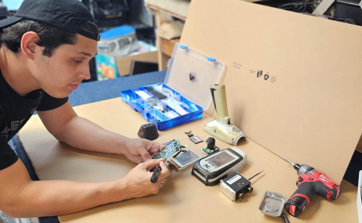Electronic Fix staffer repairing ID gun