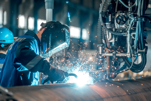 man welds at the factory