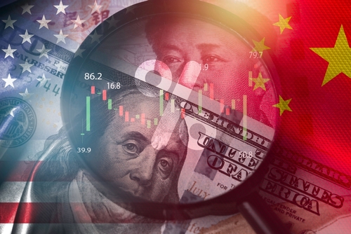 Magnifier glass focus on USD dollar and Yuan banknote with USA and China flag .It is symbol of economic tariffs trade war _tax barrier and tech competition which it effect to global economy concept.