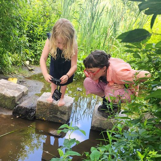 ICG staff member Annika joins summer camper in nature photography at ICG