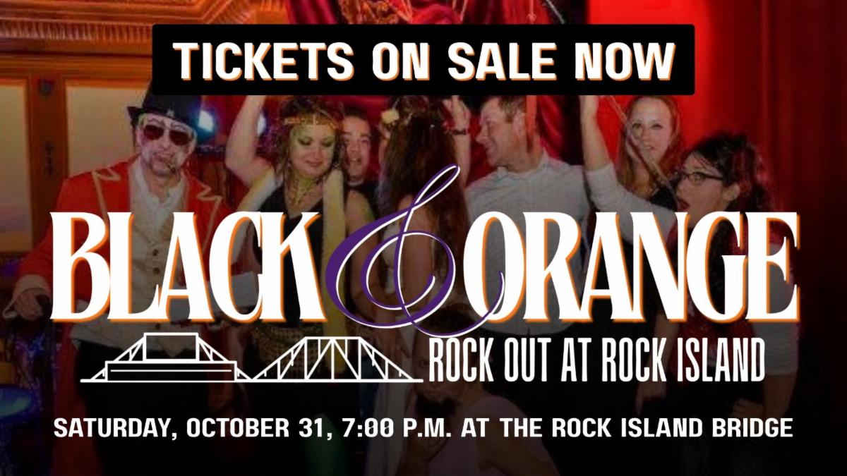 Group photo of past costume contest winners standing on stage in front of a red curtain. Text at the top reads "Tickets on Sale Now!" and at the bottom is the Black and Orange logo with "Saturday, October 31, 7:00 p.m. at the Rock Island Bridge" in white text at the bottom.