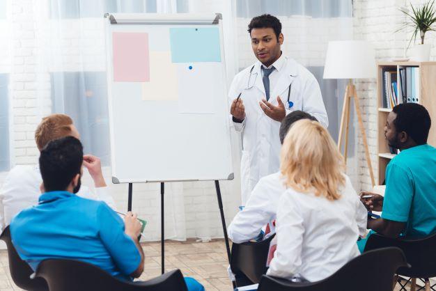 male doctor conducting training with small group