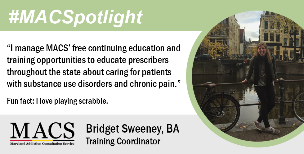 MACS training coordinator, bridget, poses in front of an urban canal and bike