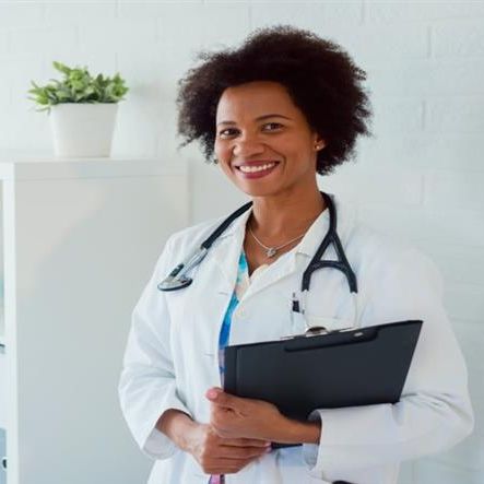 doctor smiling with clipboard