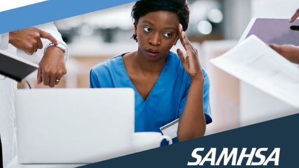 nurse in scrubs looking stressed