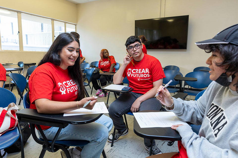 Cal State LA student mentors and mentees working on goals together as part of the university's College Readiness, Achievement and Retention (CREAR) Futuros program. 