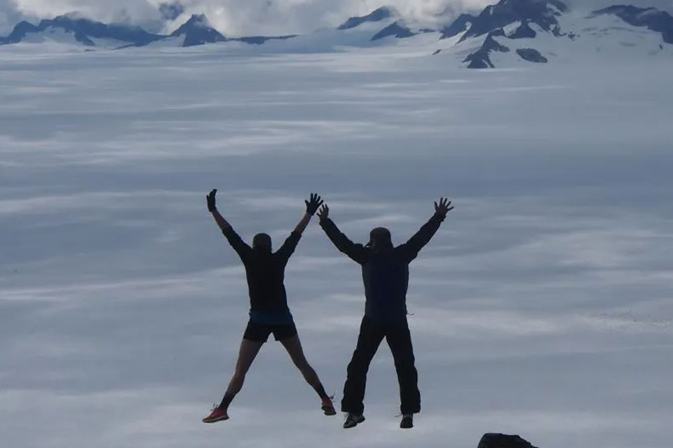 Participants in the Juneau Icefield Research Program jump while overlooking the Taku Glacier in southeast Alaska.