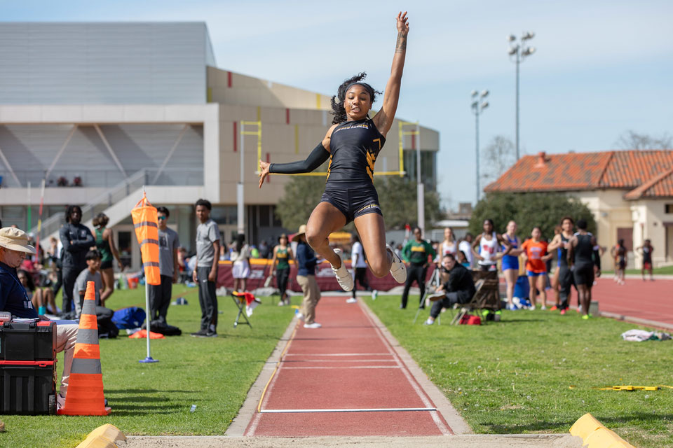 Jonon Young goes for a long jump.