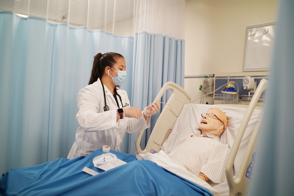 Photo: A nursing student receives hands-on training in a simulation lab.