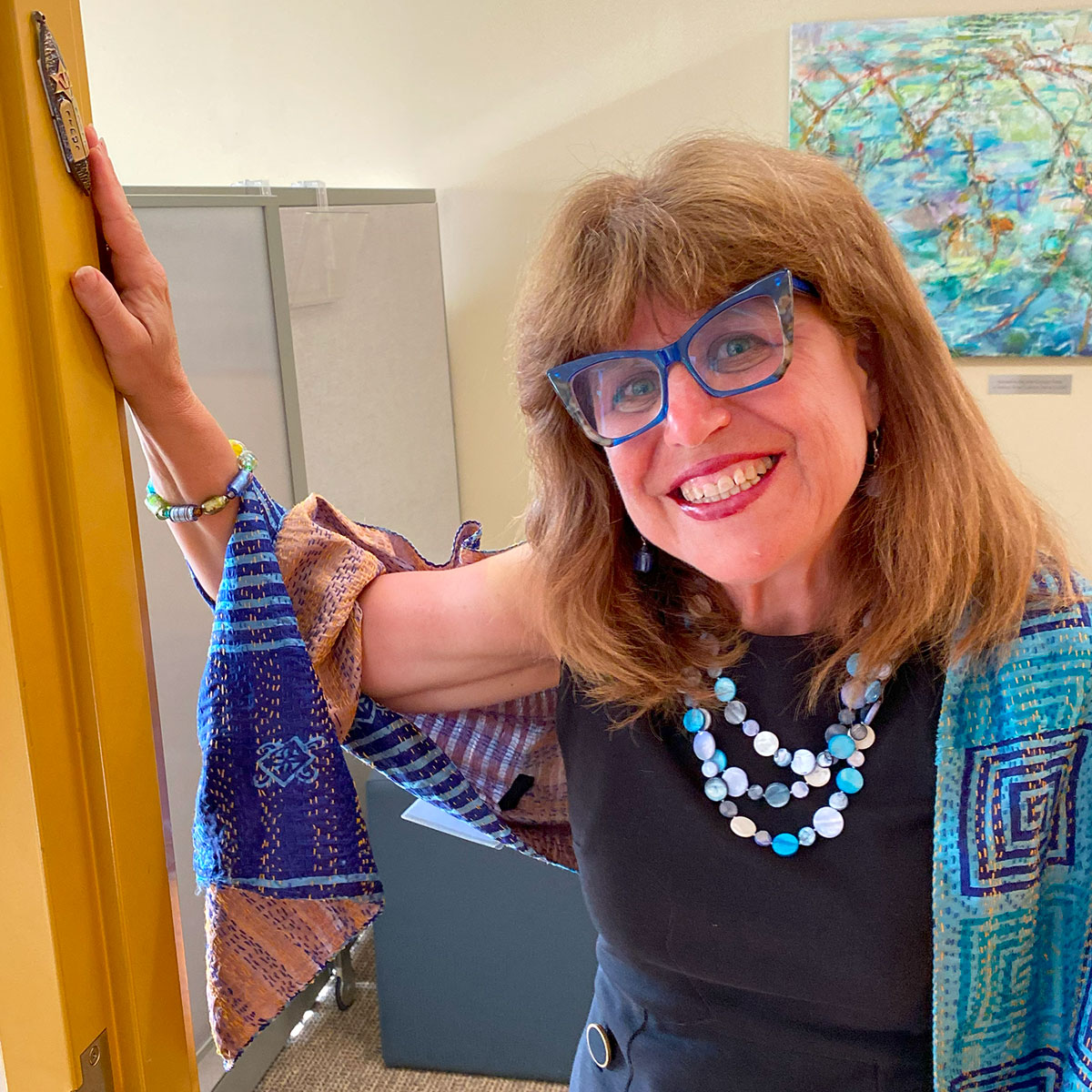 JF&CS CEO Gail Schulman touching mezuzah