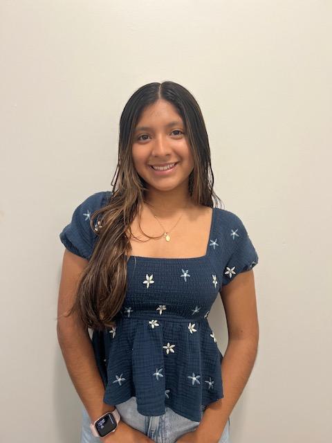 Professional headshot of Pamela Torres standing in front of a white background