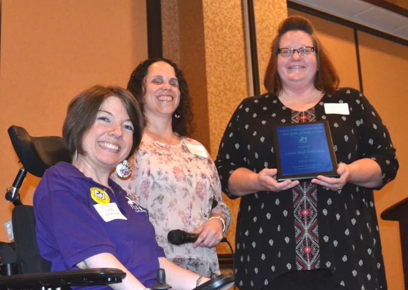 Chrisi Reif-Fuhrman takes a photo with Carrie and Julia while holding her award