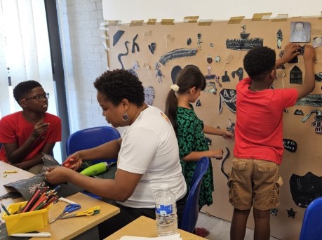 Black Asian and Minority Ethnic children enjoying an art workshop.