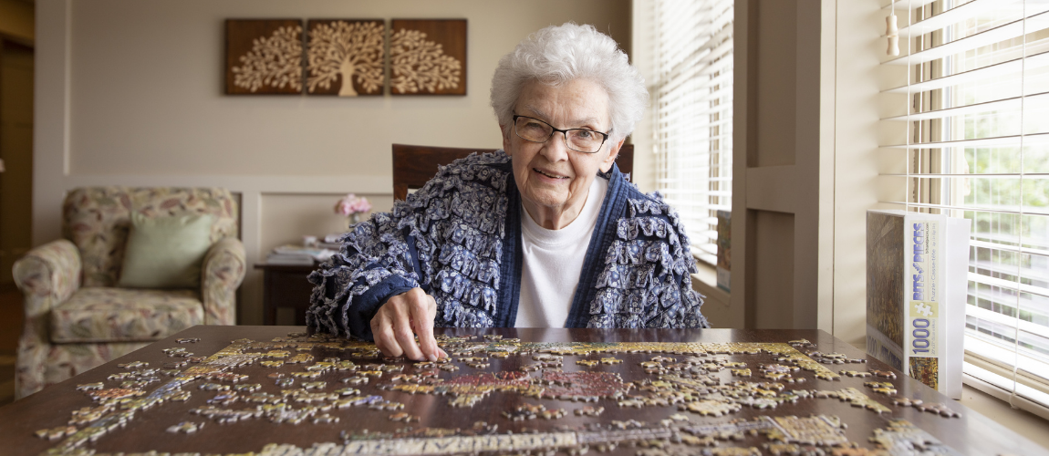 Older woman doing a jigsaw puzzle