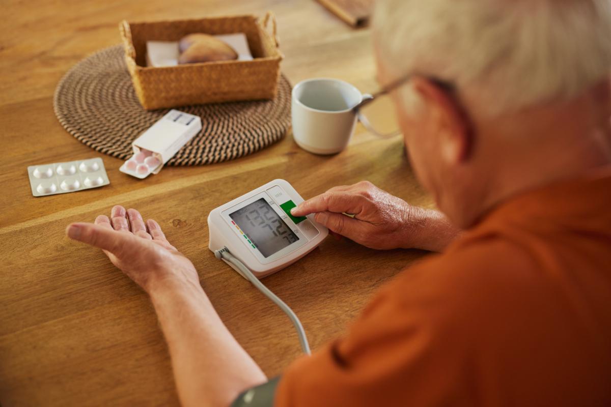Man checking his blood pressure at home