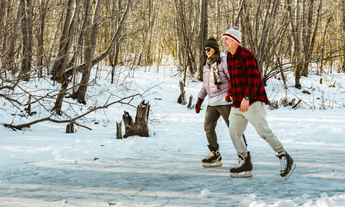 couple ice-skating on a frozen pond