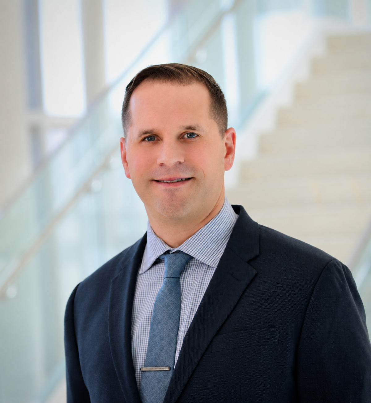 Daniel J. Amante, white man with brown hair wearing a navy suit