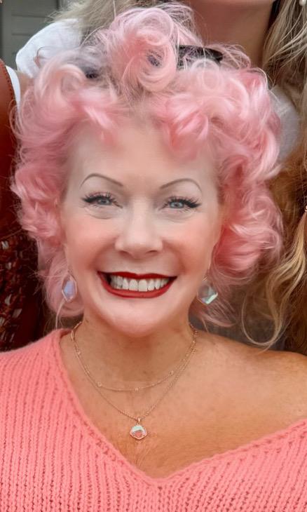 Laurell Labdon with cotton candy pink hair wearing a pink sweater
