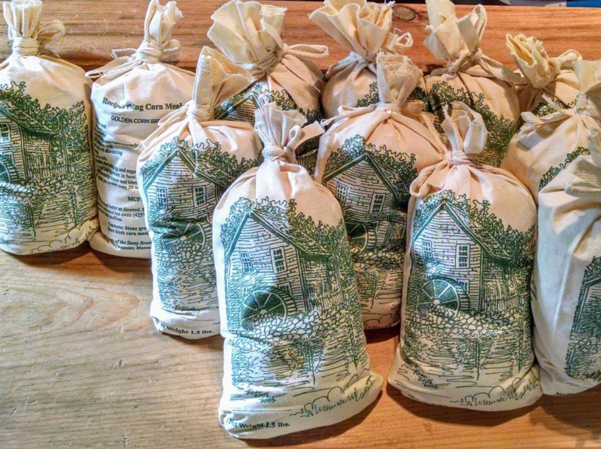 Bags of cornmeal in fabric bags with the mill printed on it
