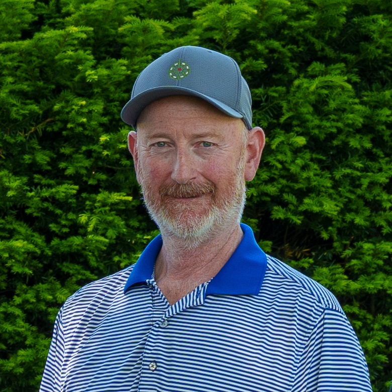 Tom Flynn in a striped golfing polo and hat