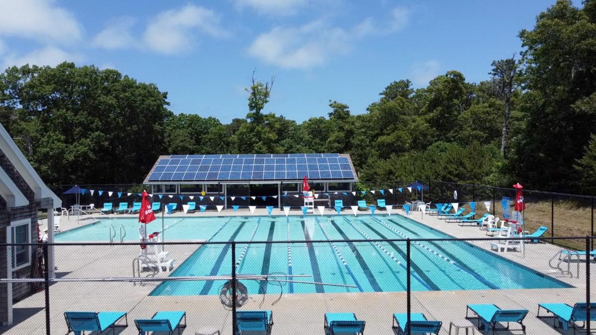 Community pool with pool furniture around the edges