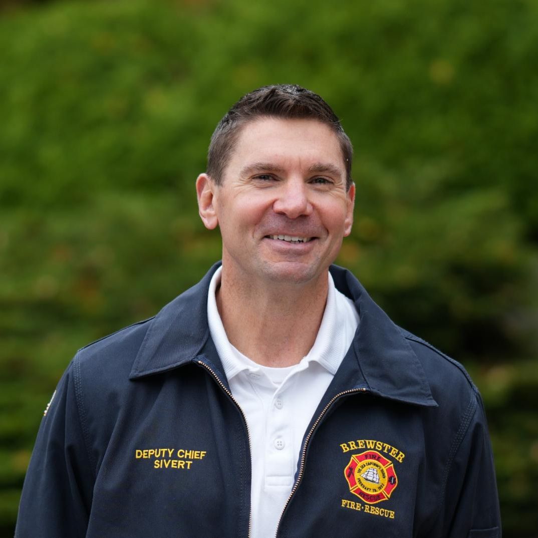Headshot of Jeff Sivert wearing a fire department jacket and he is smiling.