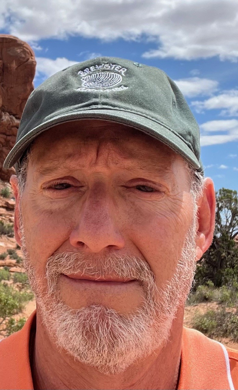 Robert is wearing a Brewster ball cap while visiting a national park in red rocks country.