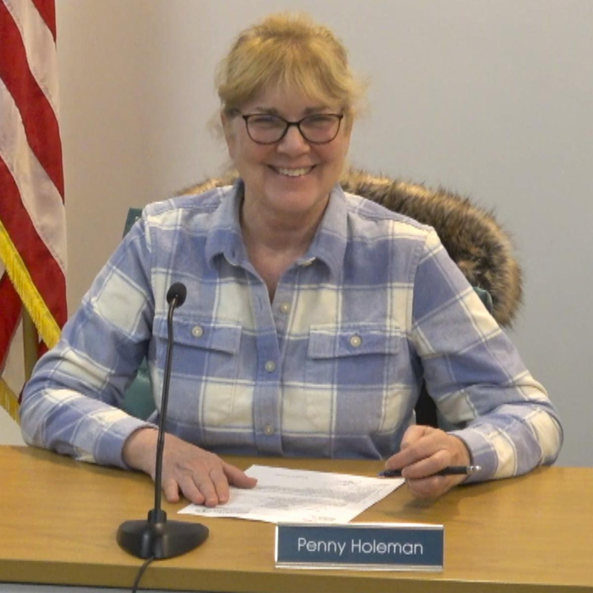 Penny Holeman sitting in a meeting and smiling