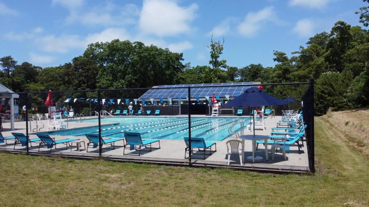 Community pool with pool furniture around the edges