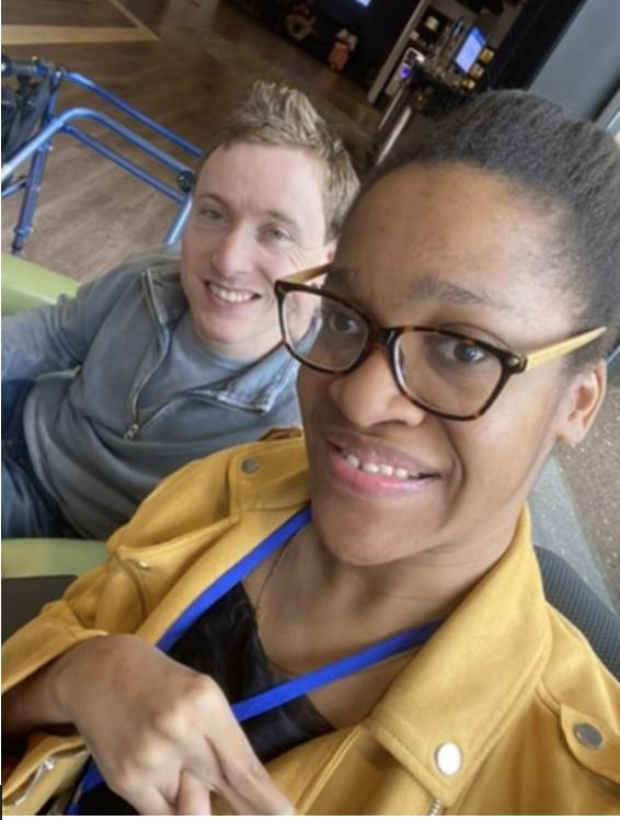 A white man and Black woman smile at the camera.