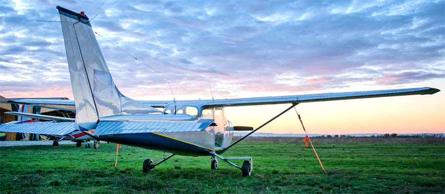 Small aircraft parked on grass.