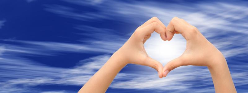 Concept or conceptual human male or man and woman hands in love, Valentines shape or symbol of heart over blue sky banner background