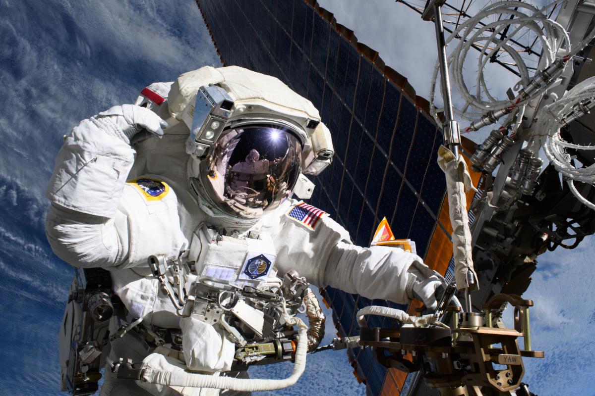 NASA astronaut Anne McClain works near one of the International Space Station’s main solar arrays during a spacewalk. 